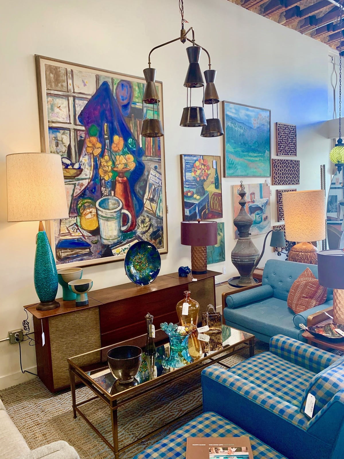 Blue armchairs, painting, and blue lamps