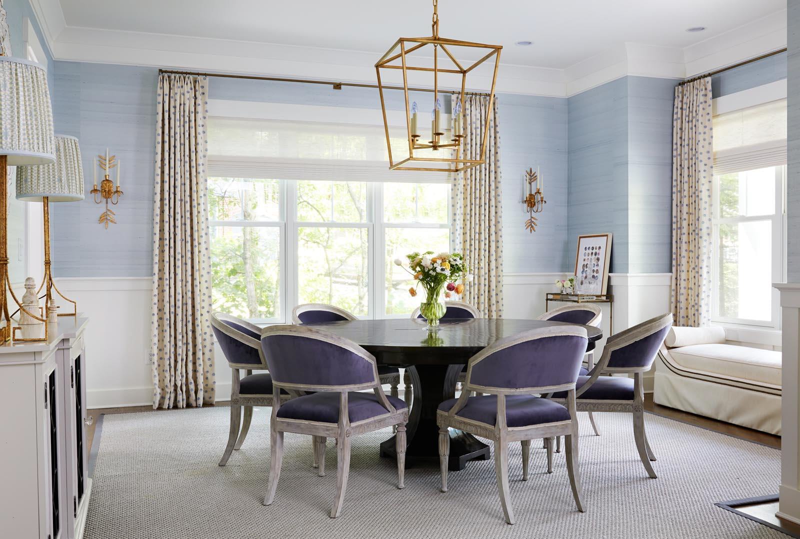 Dining room with purple chairs and blue walls